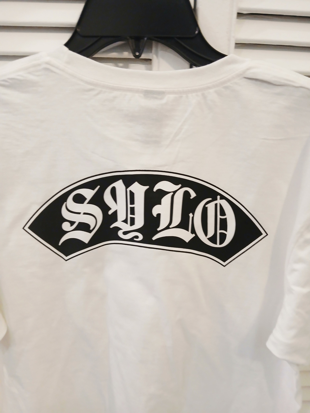 White Graphic Tee with Black 'SYLO'Support Your Local Outlaws Arch Logo